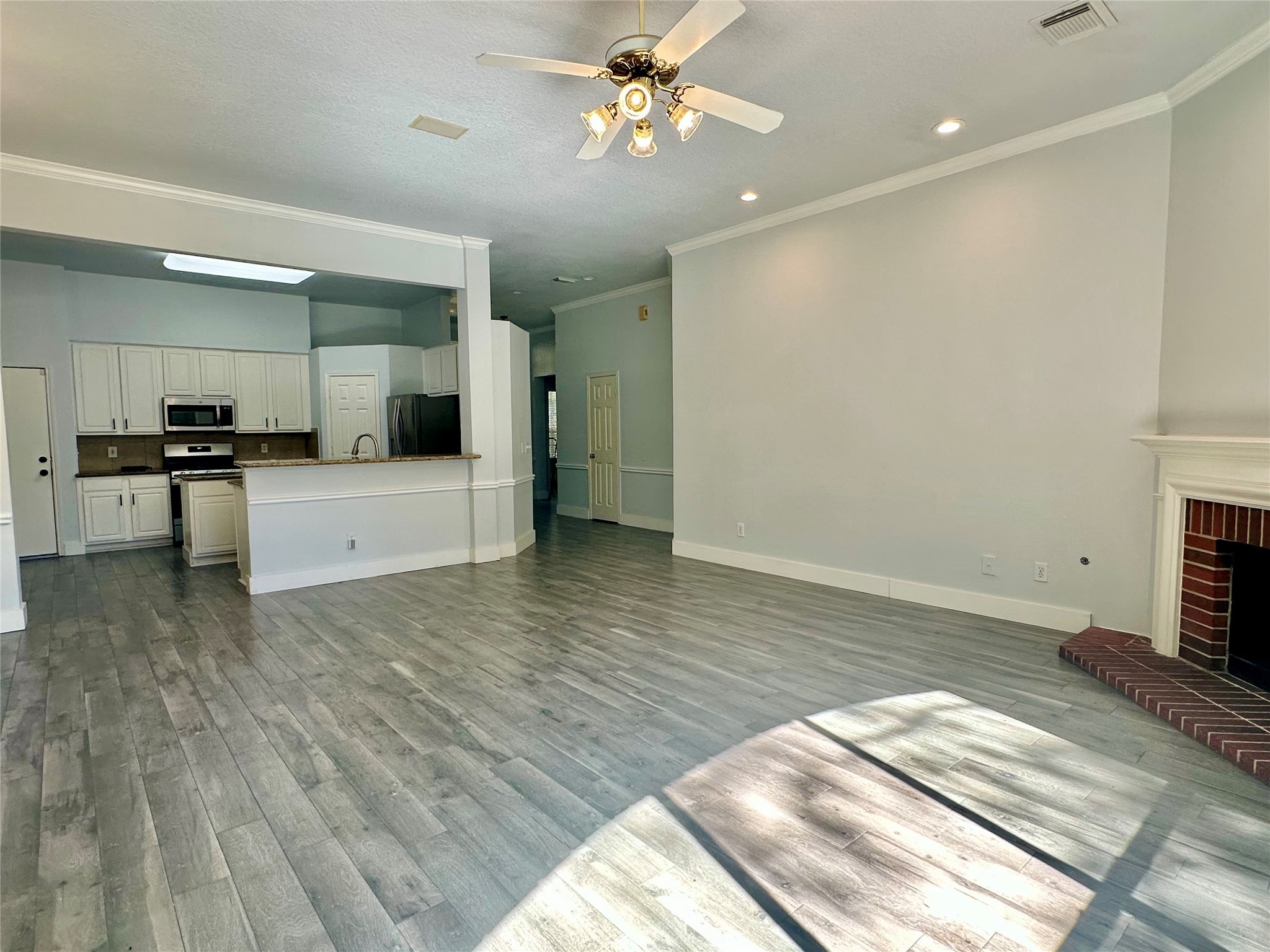 18 South Willow Point Circle Spring, TX 77382 - Photo 27 of 27 a view of a kitchen with wooden floor and a ceiling fan