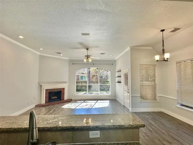 a kitchen with stainless steel appliances granite countertop a refrigerator sink and stove