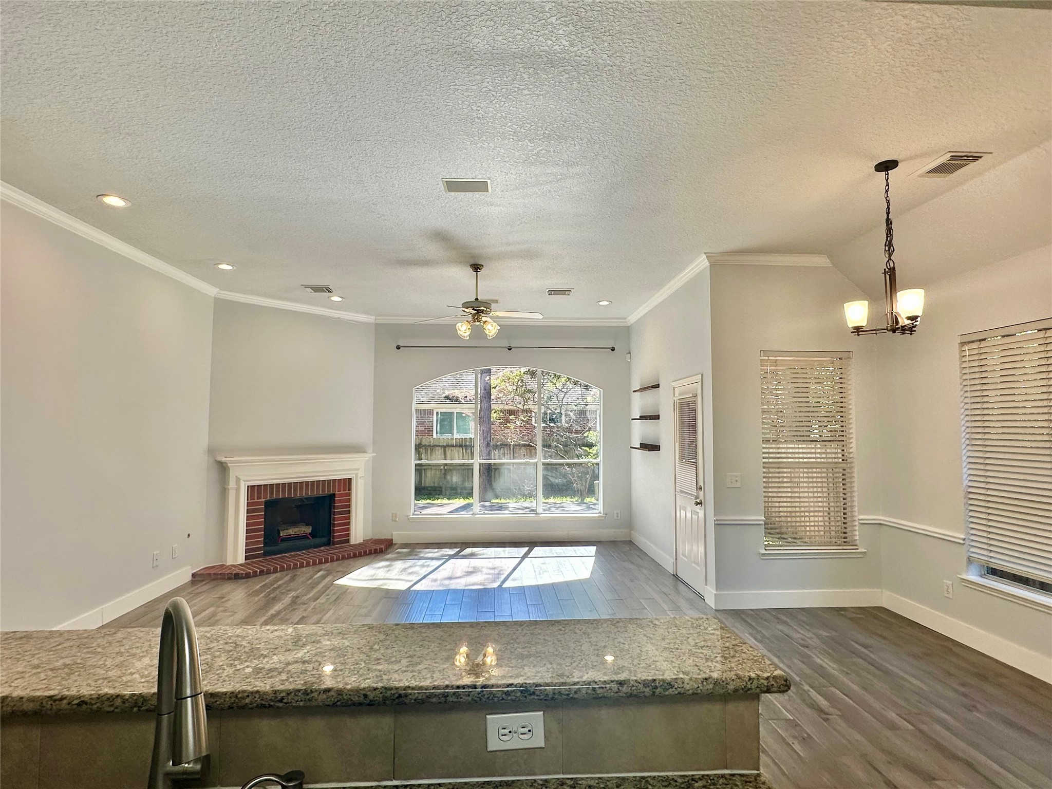 18 South Willow Point Circle Spring, TX 77382 - Photo 7 of 27 a kitchen with kitchen island granite countertop a stove and a sink