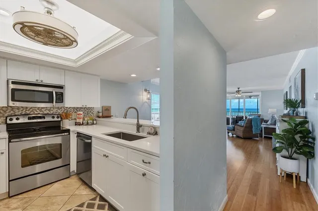 a bathroom with a granite countertop sink a mirror and a shower