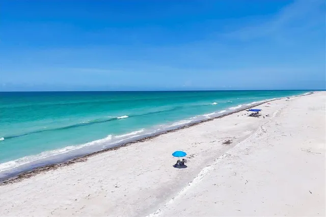a view of a ocean beach and city