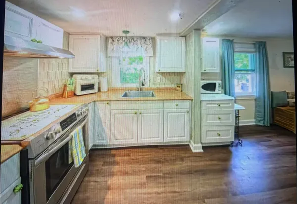 a kitchen with a stove top oven sink and cabinets
