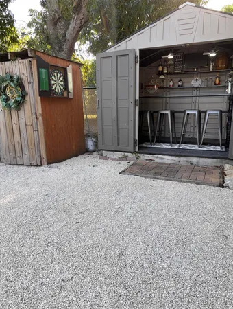 a view of backyard of house with outdoor seating