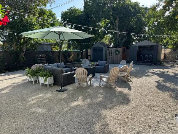 a view of a chairs and tables in the back yard of the house