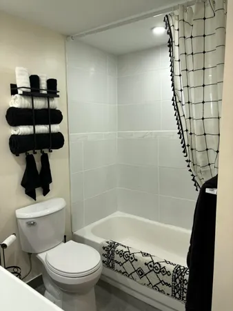 a bathroom with a toilet and a shower