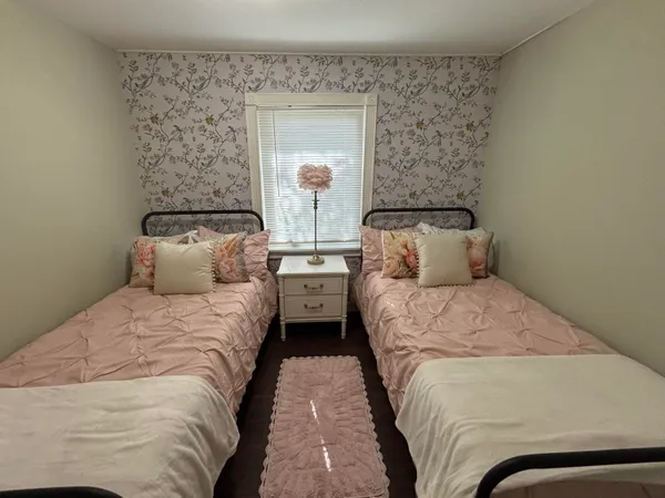 a bedroom with a bed and a mirror