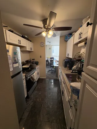 a kitchen with a sink appliances and cabinets