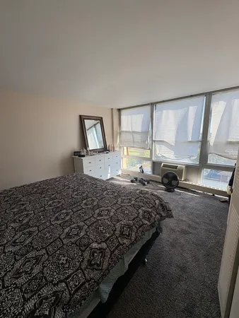 a bedroom with a bed and window