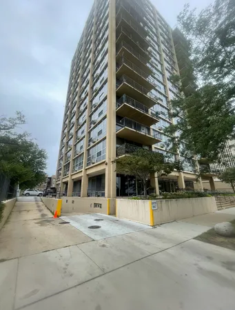 a view of tall building with large trees