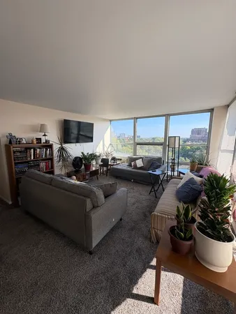 a living room with furniture and a large window