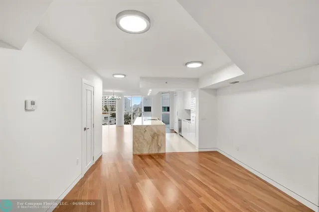 a view of kitchen and hall with wooden floor