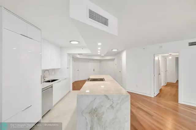 a kitchen with granite countertop a sink and stainless steel appliances