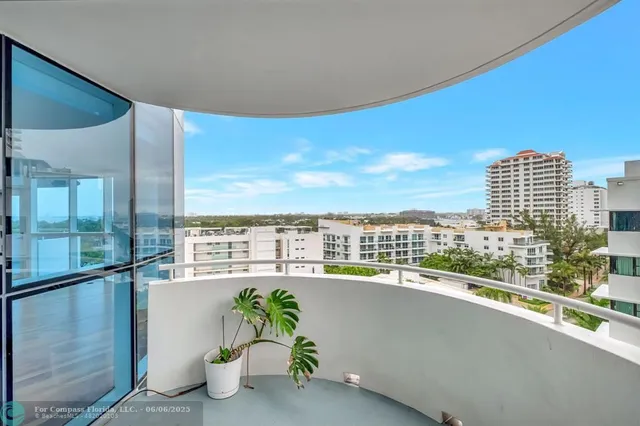 a view of a balcony with floor to ceiling windows and floor