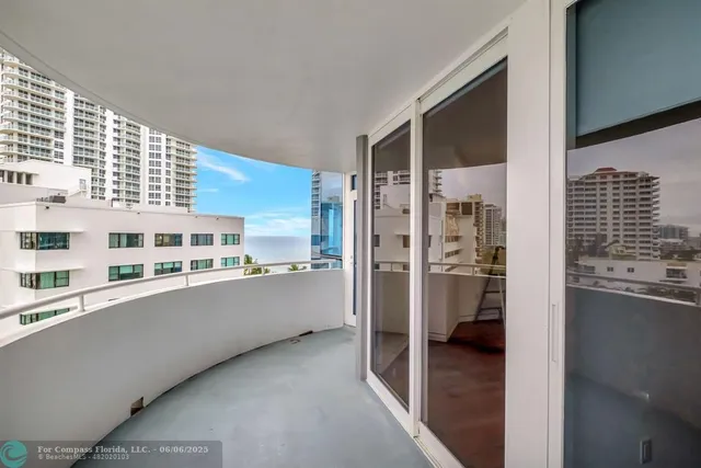 a view of a kitchen with refrigerator and cabinets