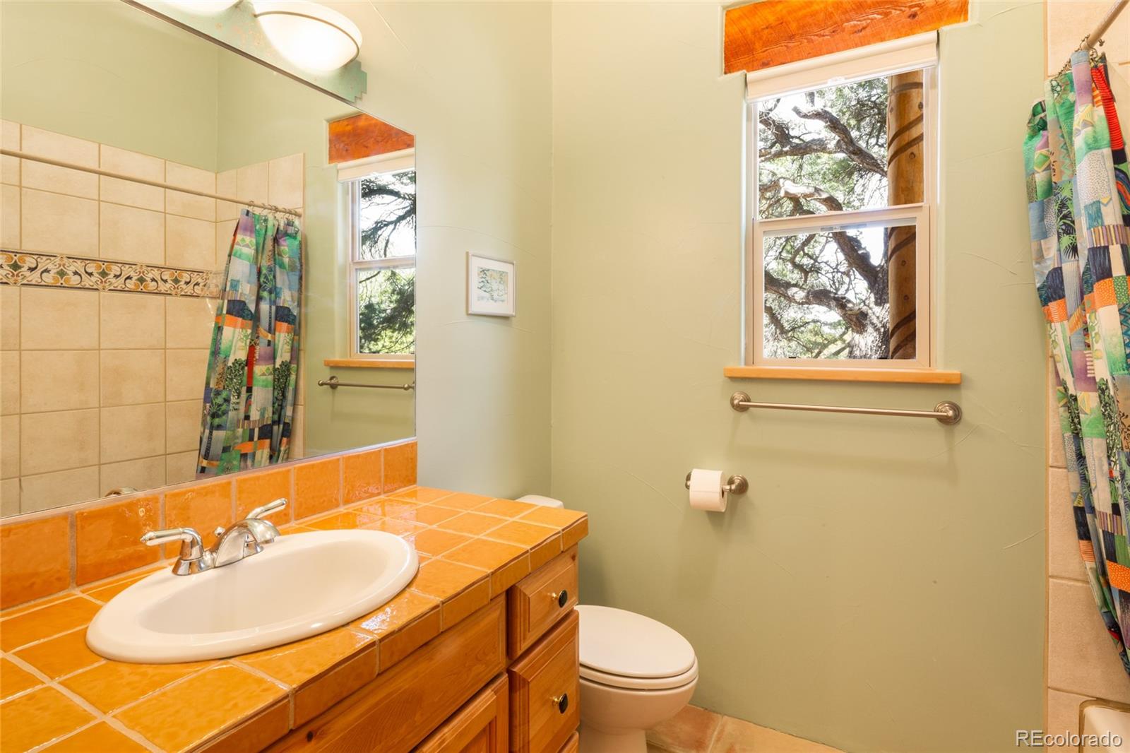 1329 Moonlight Way Crestone, CO 81131 - Photo 19 of 50 a bathroom with a granite countertop sink and a mirror