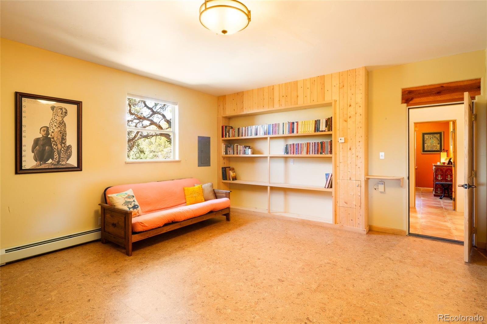 1329 Moonlight Way Crestone, CO 81131 - Photo 21 of 50 a living room with a couch and a bookshelf