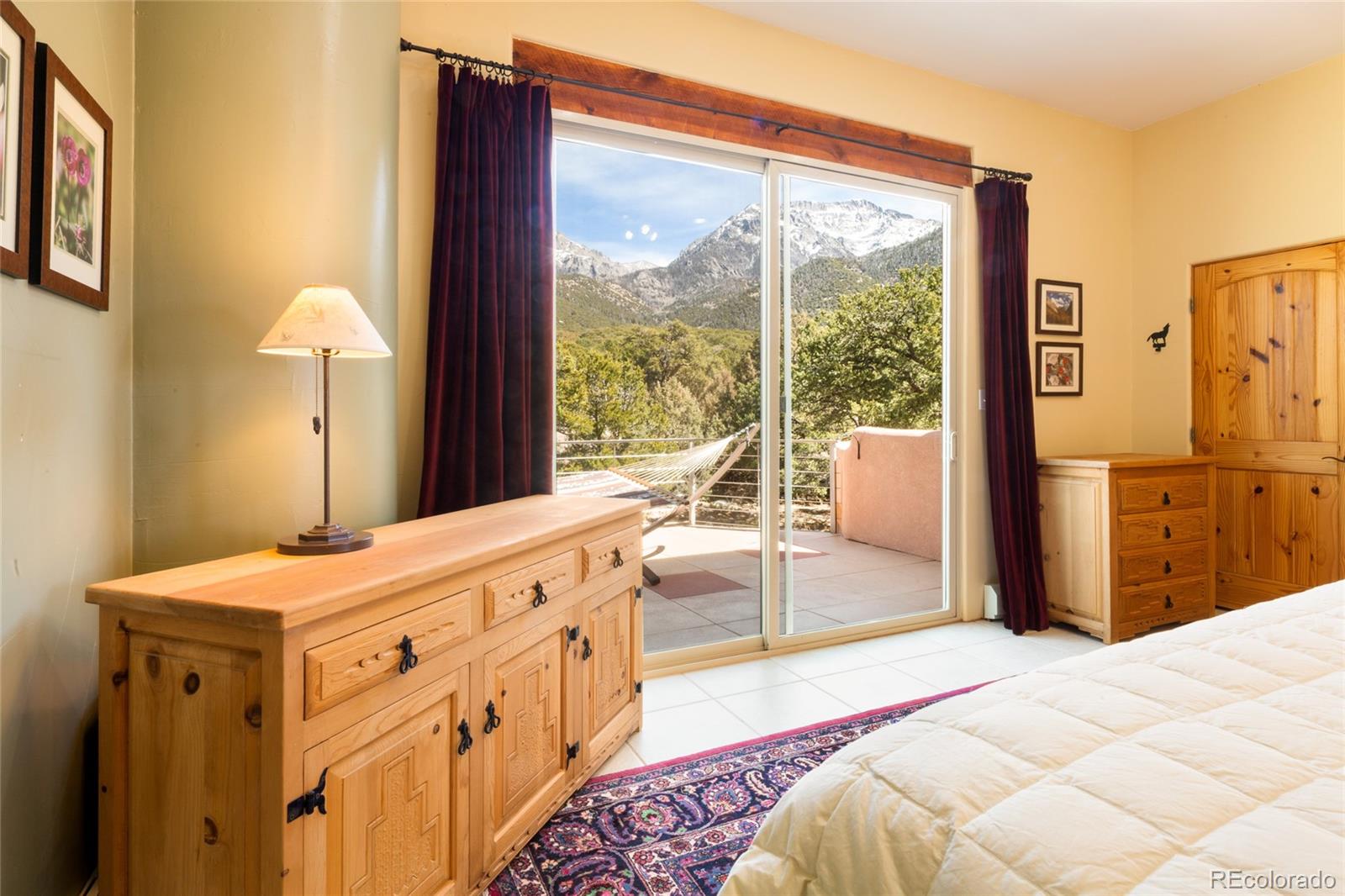 1329 Moonlight Way Crestone, CO 81131 - Photo 25 of 50 a spacious bedroom with a bed and a large window