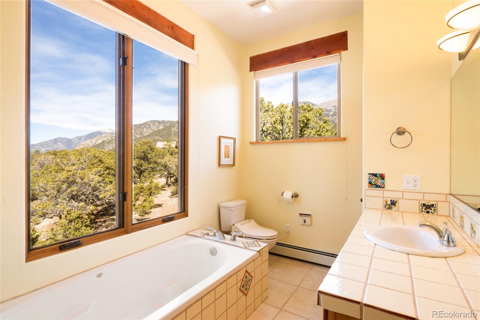 1329 Moonlight Way Crestone, CO 81131 - Photo 28 of 50 a bathroom with a sink and a large mirror next to a window