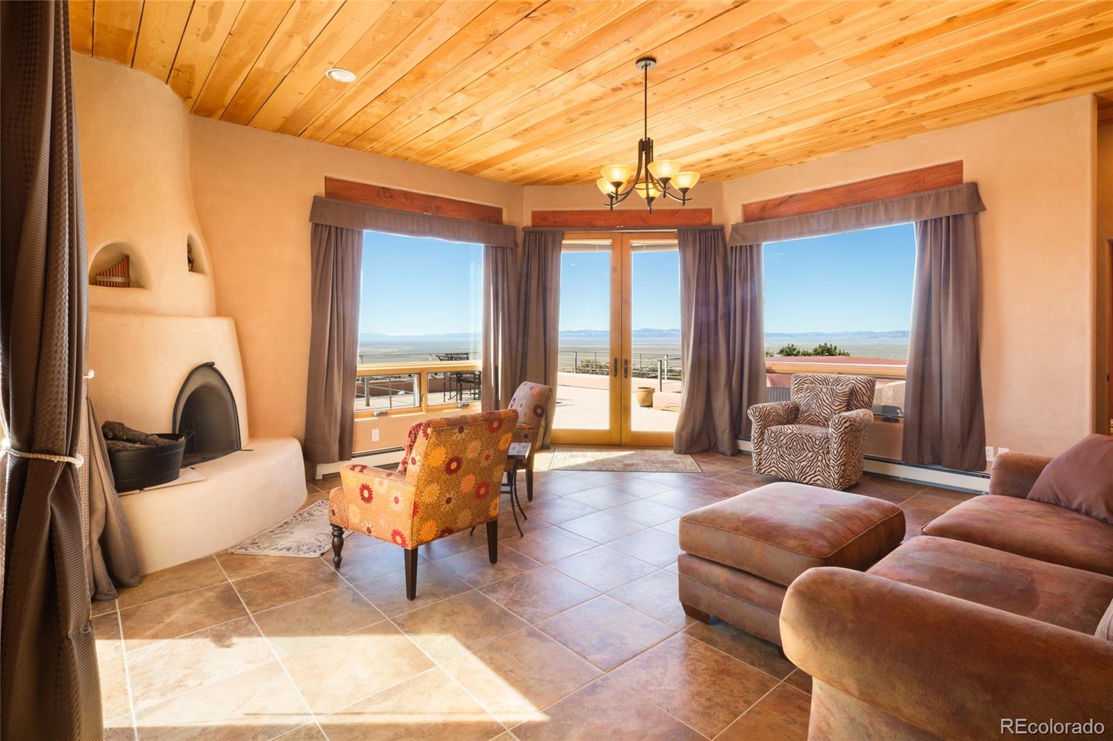 1329 Moonlight Way Crestone, CO 81131 - Photo 32 of 50 a living room with furniture a dining table and a chandelier