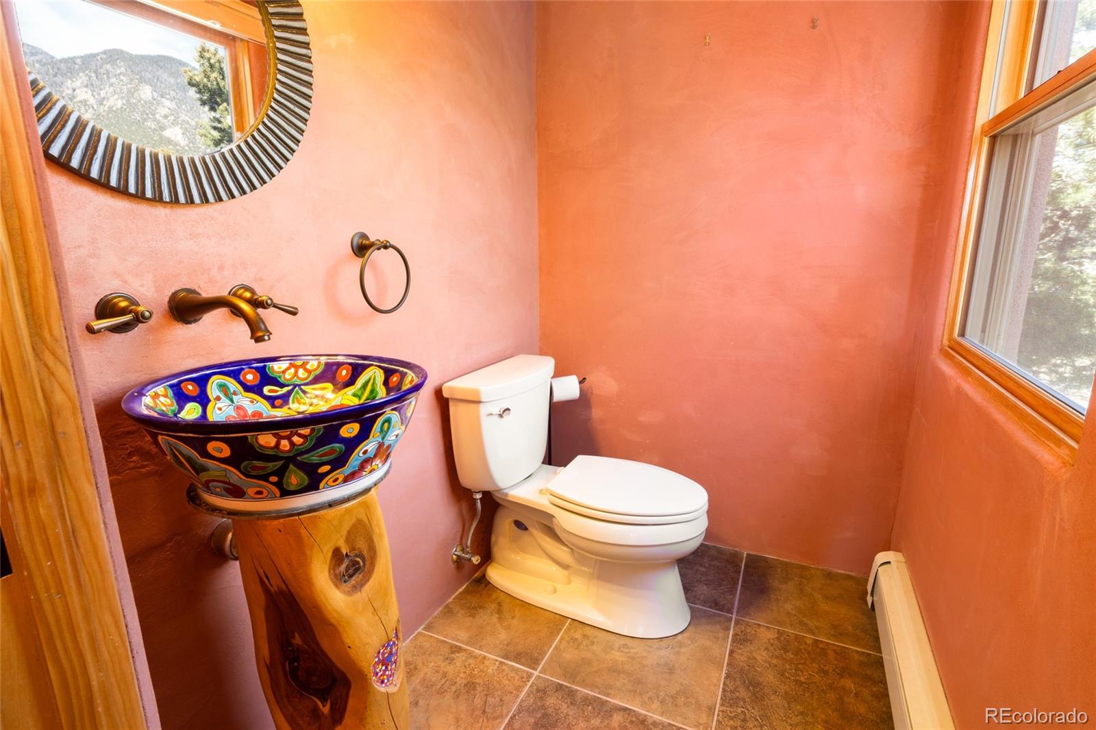 1329 Moonlight Way Crestone, CO 81131 - Photo 37 of 50 a bathroom with a toilet a sink and mirror