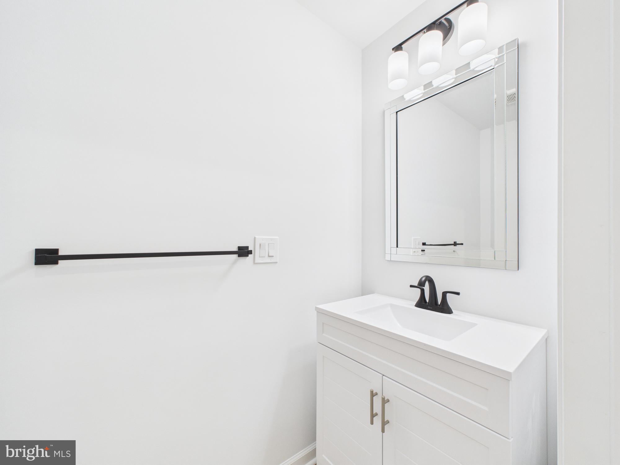 1320 Grove Street, Unit 2 Philadelphia, PA 19146 - Photo 12 of 15 a bathroom with a sink and a mirror