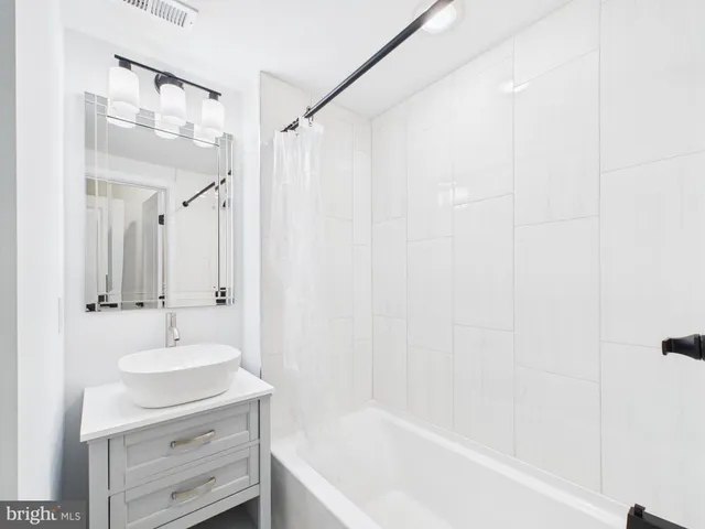 a bathroom with a sink a mirror and a bathtub