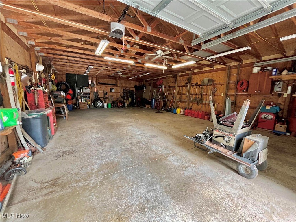 6543 North Ridge Road East Geneva, OH 44041 - Photo 39 of 49 Garage with a garage door opener and a workshop area