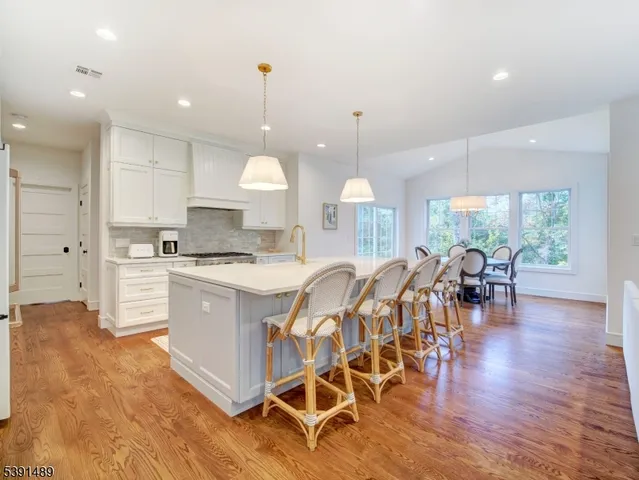 a large kitchen with lots of counter space a sink and appliances