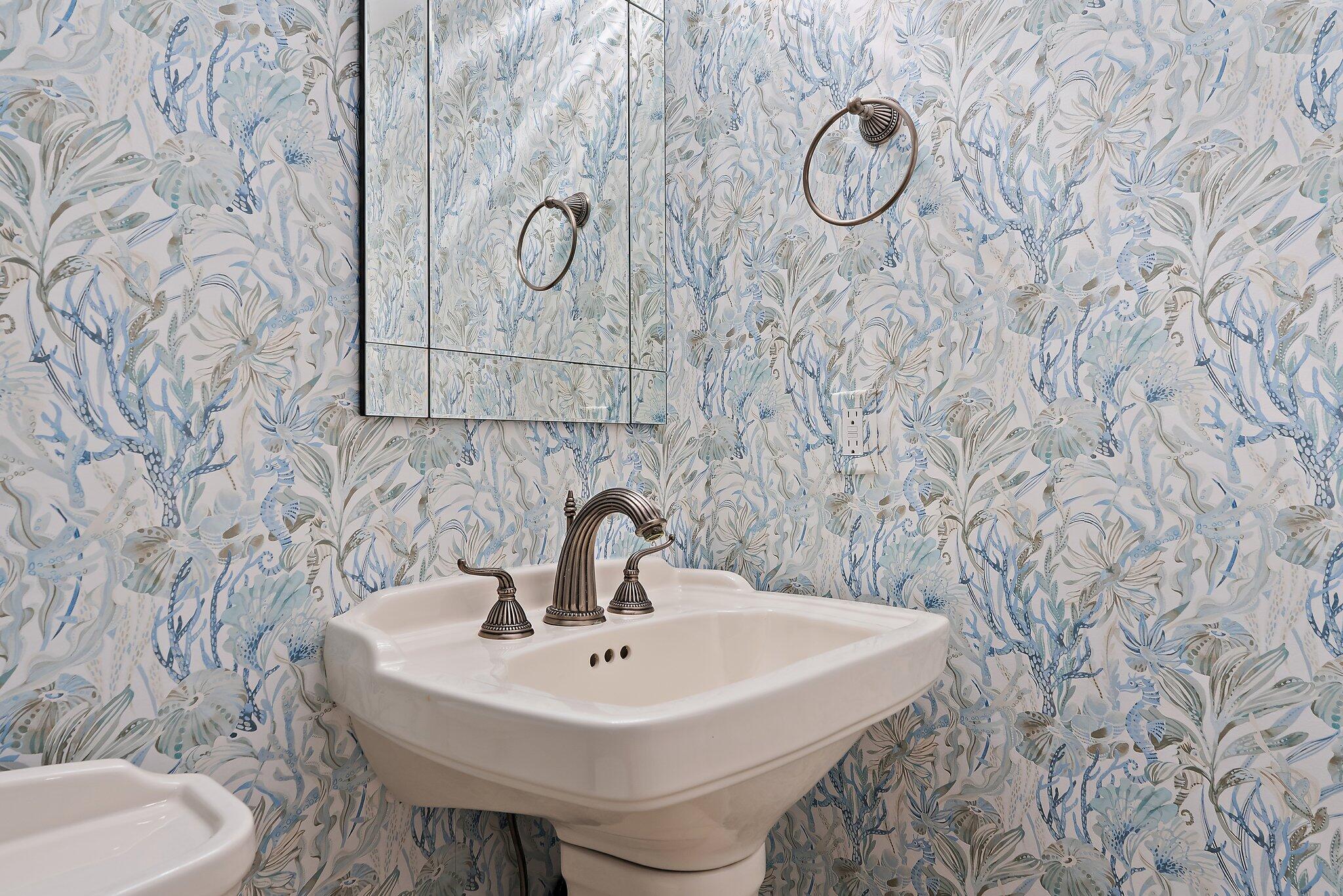 19670 South Beach Road, Unit B303 Jupiter, FL 33469 - Photo 30 of 104 a bathroom with a sink and mirror with toilet