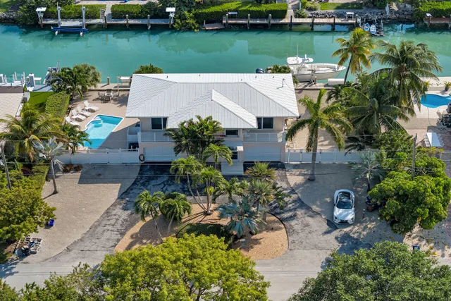 an aerial view of a house with outdoor space and lake view