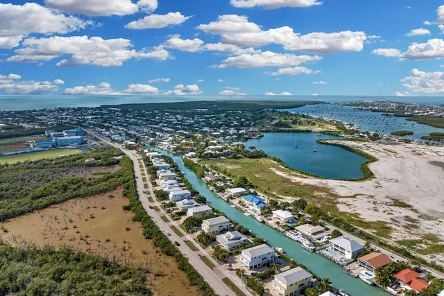 a view of a patio with dining table and chairs with wooden floor