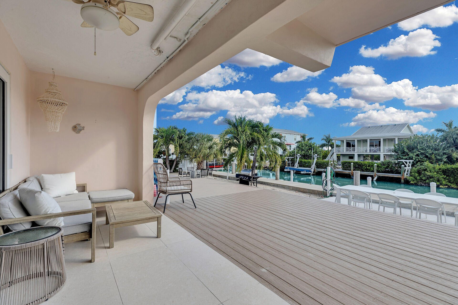 1850 Manor Lane Marathon, FL 33050 - Photo 54 of 67 a view of a patio with dining table and chairs with wooden floor