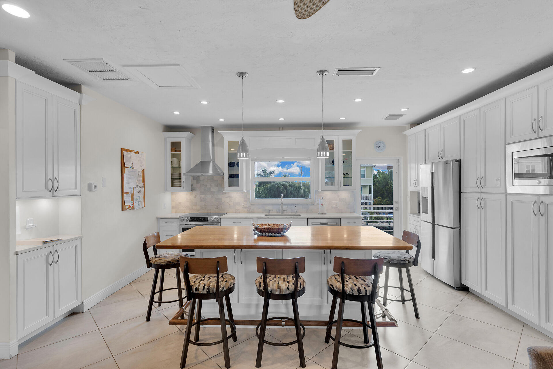 1850 Manor Lane Marathon, FL 33050 - Photo 59 of 67 a kitchen with stainless steel appliances kitchen island granite countertop a dining table chairs and white cabinets