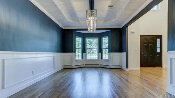 wooden floor in an empty room with a kitchen