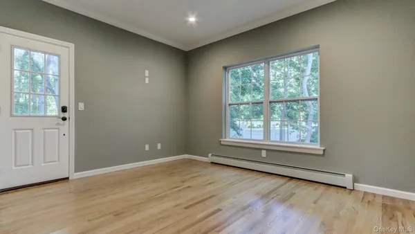 wooden floor in an empty room with a window
