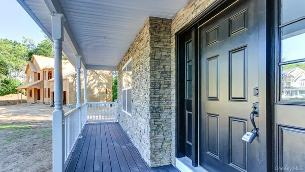 a view of a porch with wooden floor and outdoor space