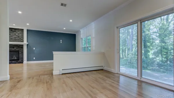a kitchen with stainless steel appliances kitchen island wooden cabinets and wooden floors