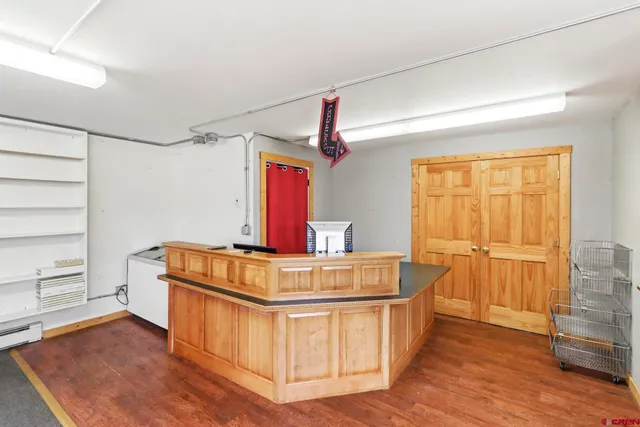 a view of kitchen with furniture and wooden floor