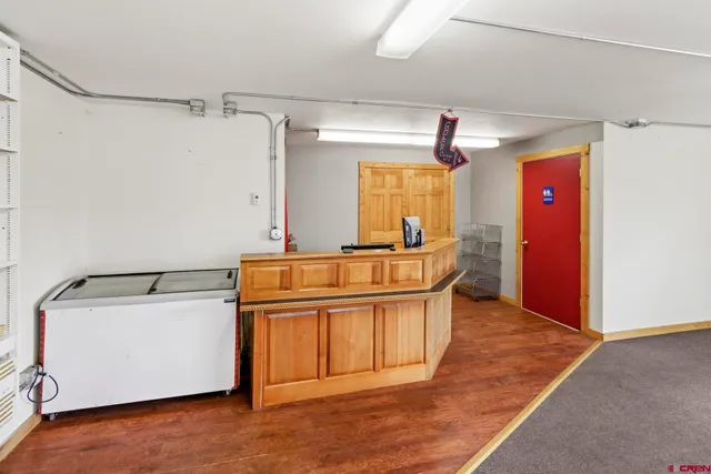 a kitchen with stainless steel appliances granite countertop a sink a stove a refrigerator and island