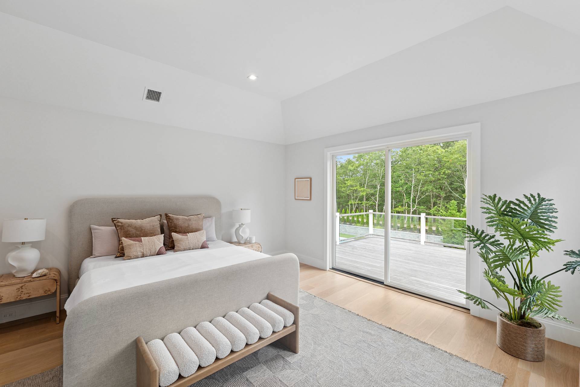 2061 Deerfield Road Sag Harbor, NY 11963 - Photo 12 of 33 a bedroom with a large bed and a potted plant