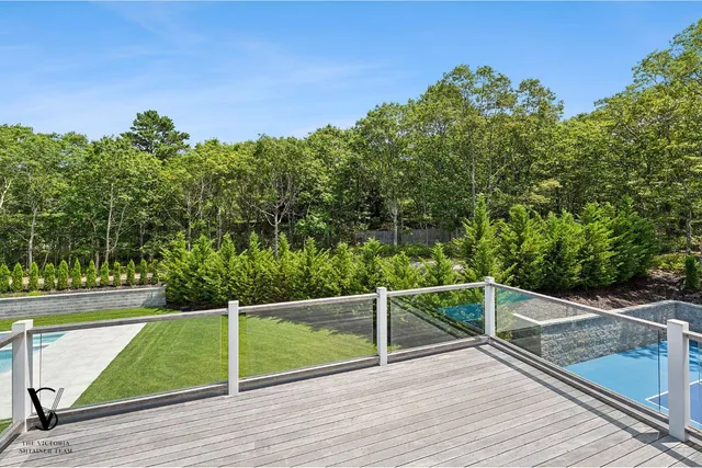 a view of a balcony with yard
