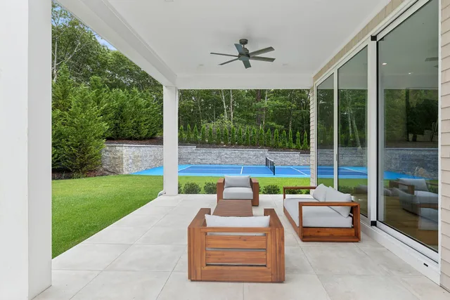 a balcony with furniture and a yard