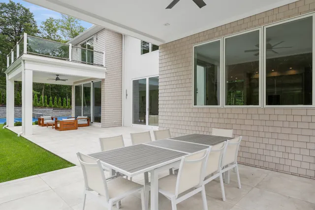 a backyard of a house with table and chairs