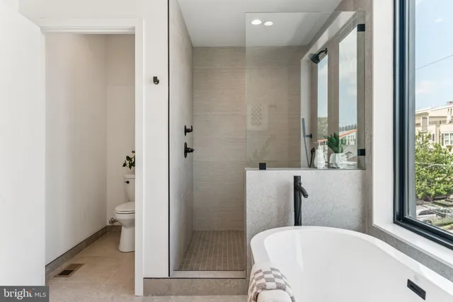 a bathroom with a tub and shower