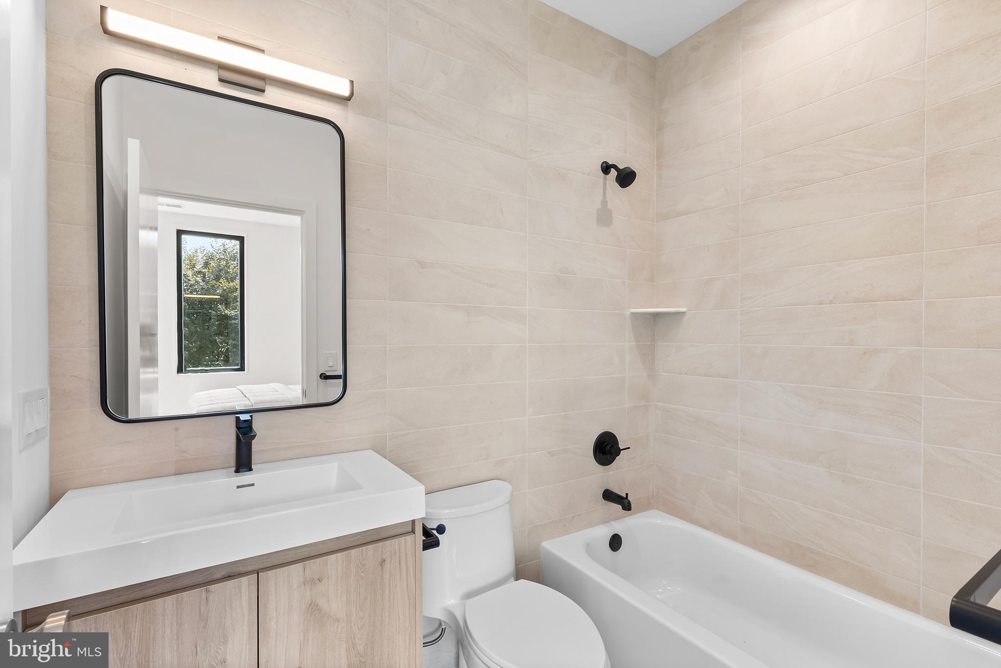 259 Delmar Street Philadelphia, PA 19128 - Photo 17 of 30 a bathroom with a sink a toilet and shower