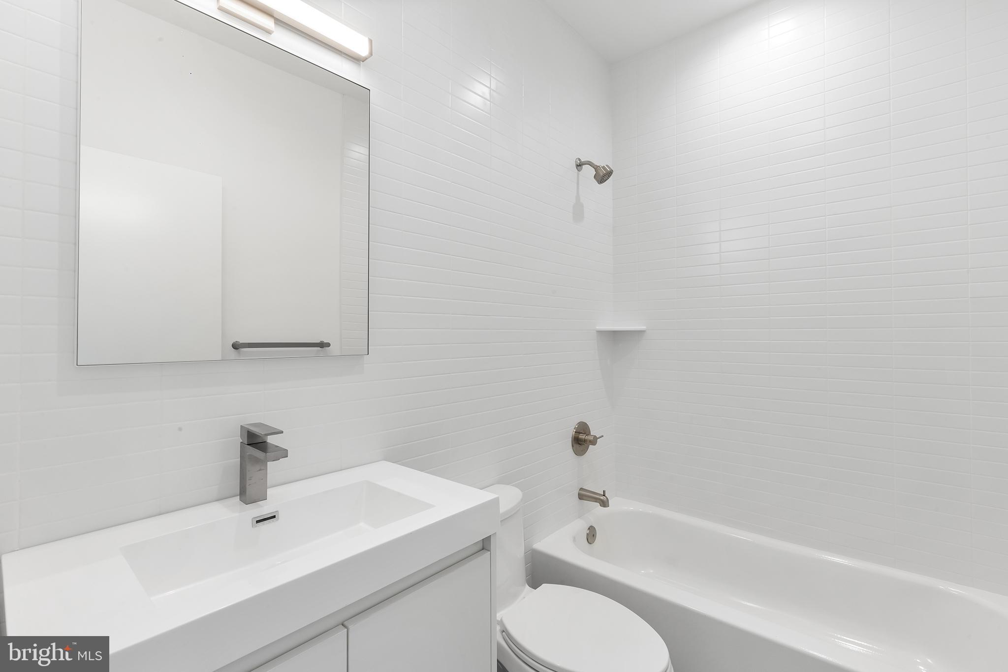 259 Delmar Street Philadelphia, PA 19128 - Photo 20 of 30 a bathroom with a bathtub shower sink vanity and toilet