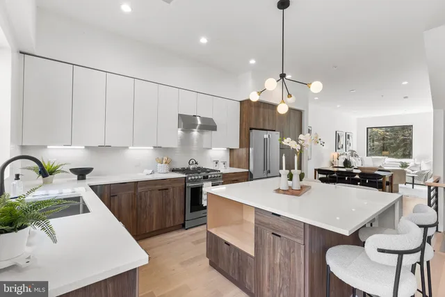 a kitchen that has a lot of cabinets a sink and a stove in it