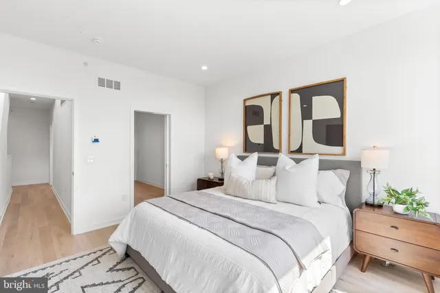 a bedroom with a bed and a potted plant