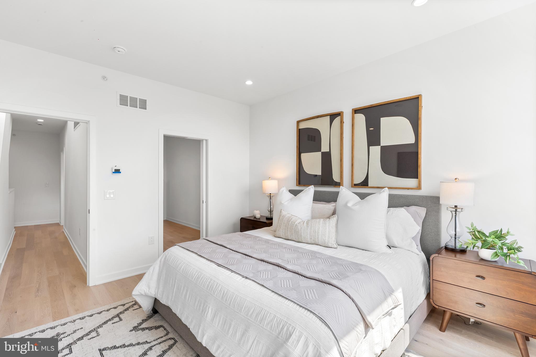 259 Delmar Street Philadelphia, PA 19128 - Photo 9 of 30 a bedroom with a bed and a potted plant