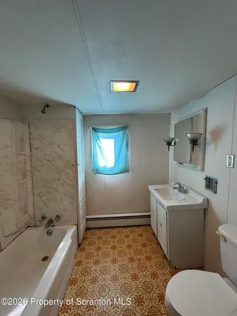 a bathroom with a sink a toilet and bathtub